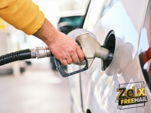 a man pumping gas into his car at a gas station