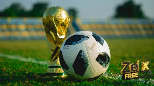 soccer ball beside trophy on soccer field