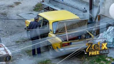 a man standing next to a yellow car