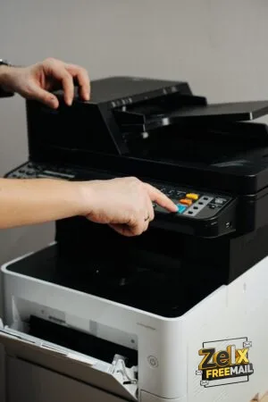 A person is pressing a button on a printer