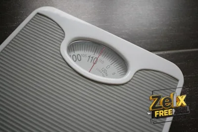 a bathroom scale sitting on top of a wooden table