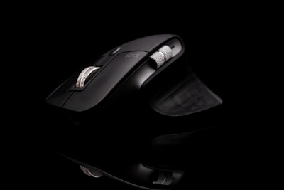 a computer mouse sitting on top of a black surface