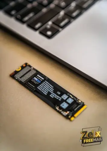 A close up of a laptop keyboard and a small piece of circuit board