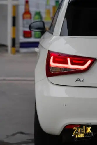 a close up of the tail light of a white car