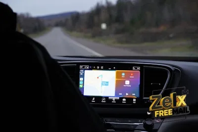 a man driving a car with a gps device in his hand