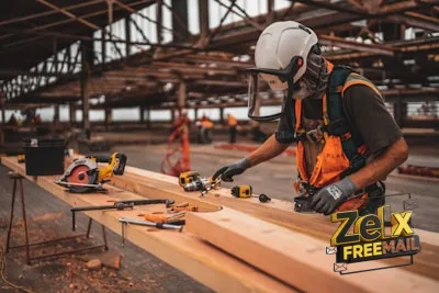 man in orange and black vest wearing white helmet holding yellow and black power tool