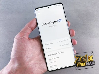 Hand holding a smartphone displaying xiaomi hyperos information.