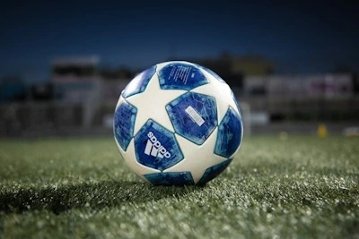 white and blue soccer ball on green grass field